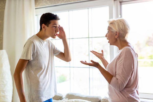 Mother and her teenage son arguing at home